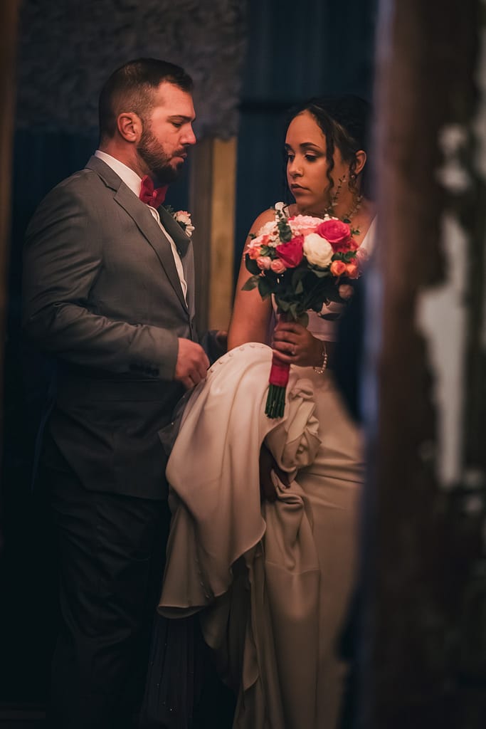 The Faded Lens | Lake Charles Wedding Photography 1 Bride holding her bouquet with her father by her side moments before walking down the aisle – captured in a quiet, emotional pause with cinematic lighting